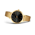 Gold watch with black dial and mesh bracelet, three-quarter view
