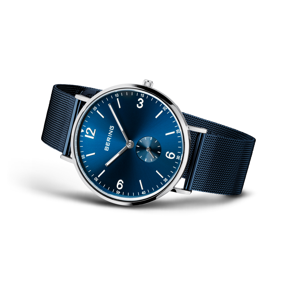BERING wristwatch with blue dial, Arabic numerals, and navy fabric strap, three-quarter view