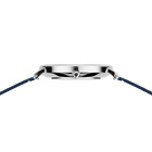 Silver watch case with black dial and navy fabric strap, viewed from above