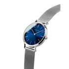Blue dial with silver case and metal mesh band, angled view showing bracelet.