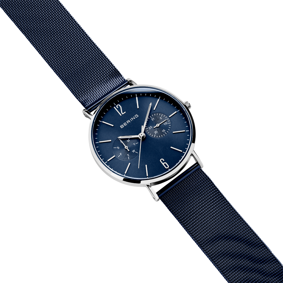 BERING wristwatch with dark blue mesh strap, silver-tone round case, and dark blue dial with white indices, shown at diagonal angle