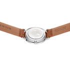 Reloj redondo plateado con correa de cuero marrón, vista superior