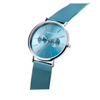BERING watch with turquoise dial, silver case, and blue mesh band, tilted to display the bracelet.
