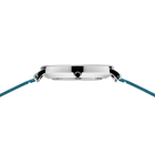 Round silver watch with black center detail and blue woven strap, viewed from above