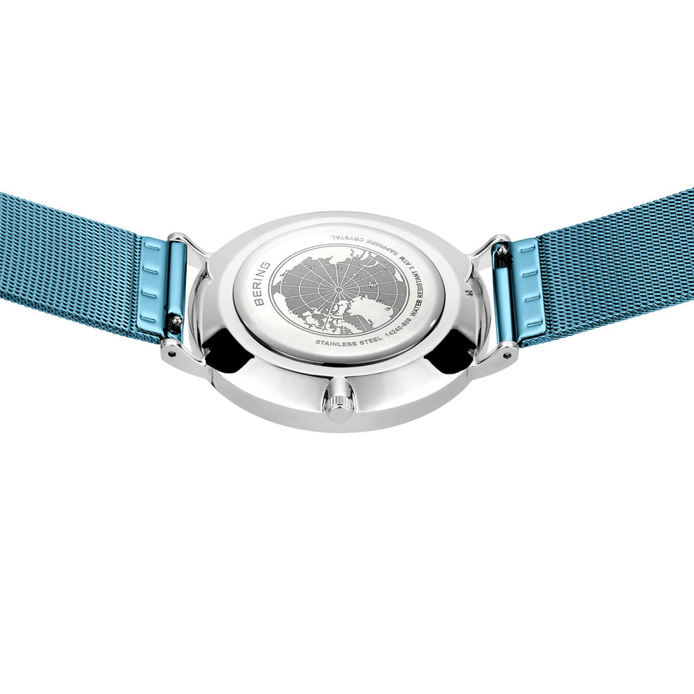 Wristwatch with silver round case and blue fabric strap, photographed from above.