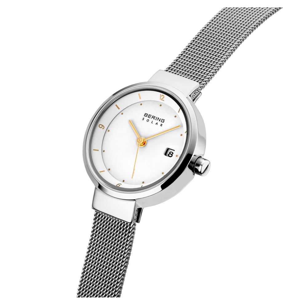 Round-face watch, white dial with orange hands, mesh stainless steel bracelet.