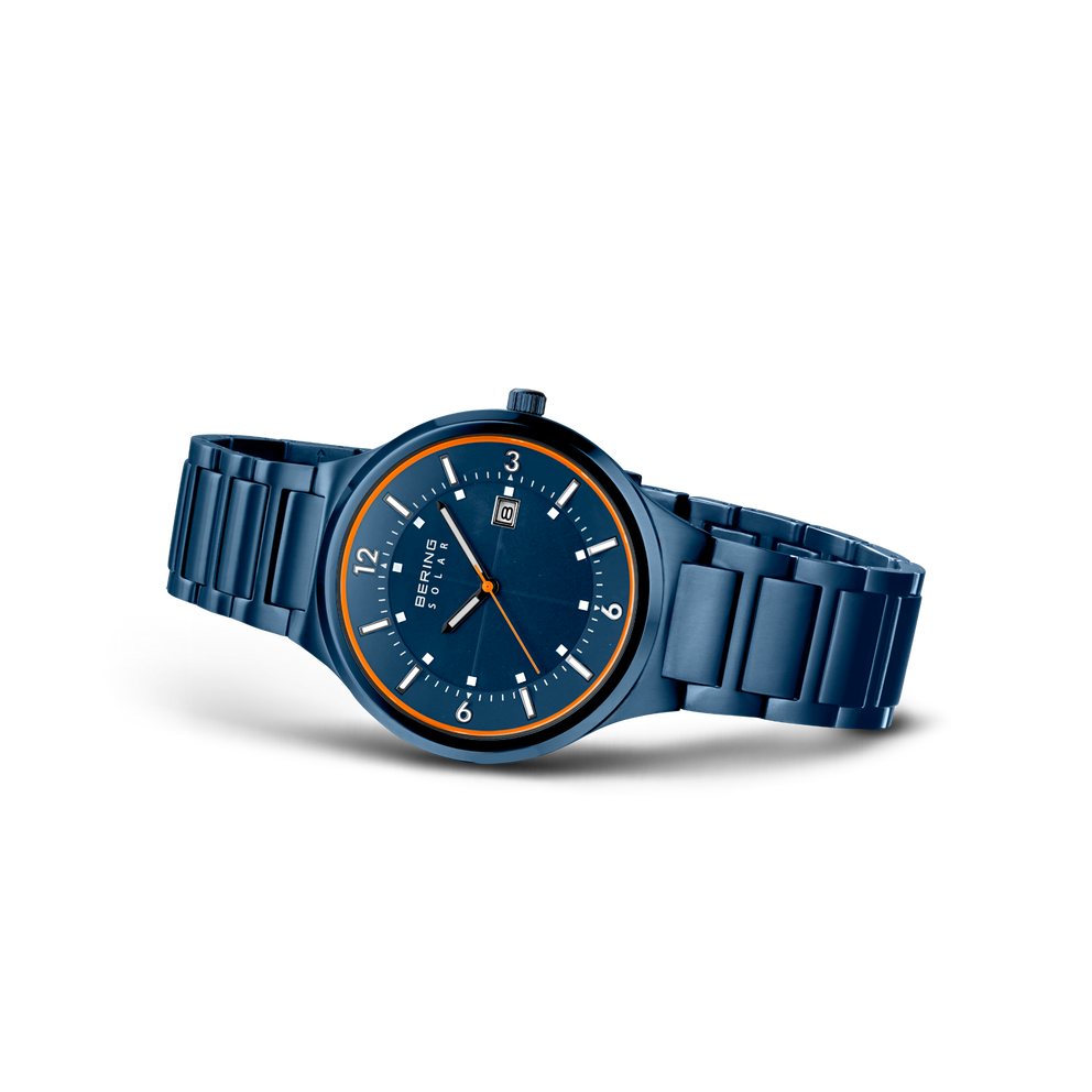 BERING wristwatch model 14442-797 with dark blue dial, gold bezel, and matching blue steel bracelet, shown at angle.