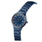 Dark blue watch with gold bezel accents, three-quarter view showing dial and steel bracelet.