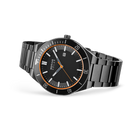 Black-dial wristwatch with metal bracelet, angled view showing orange bezel and hand accents, date window.
