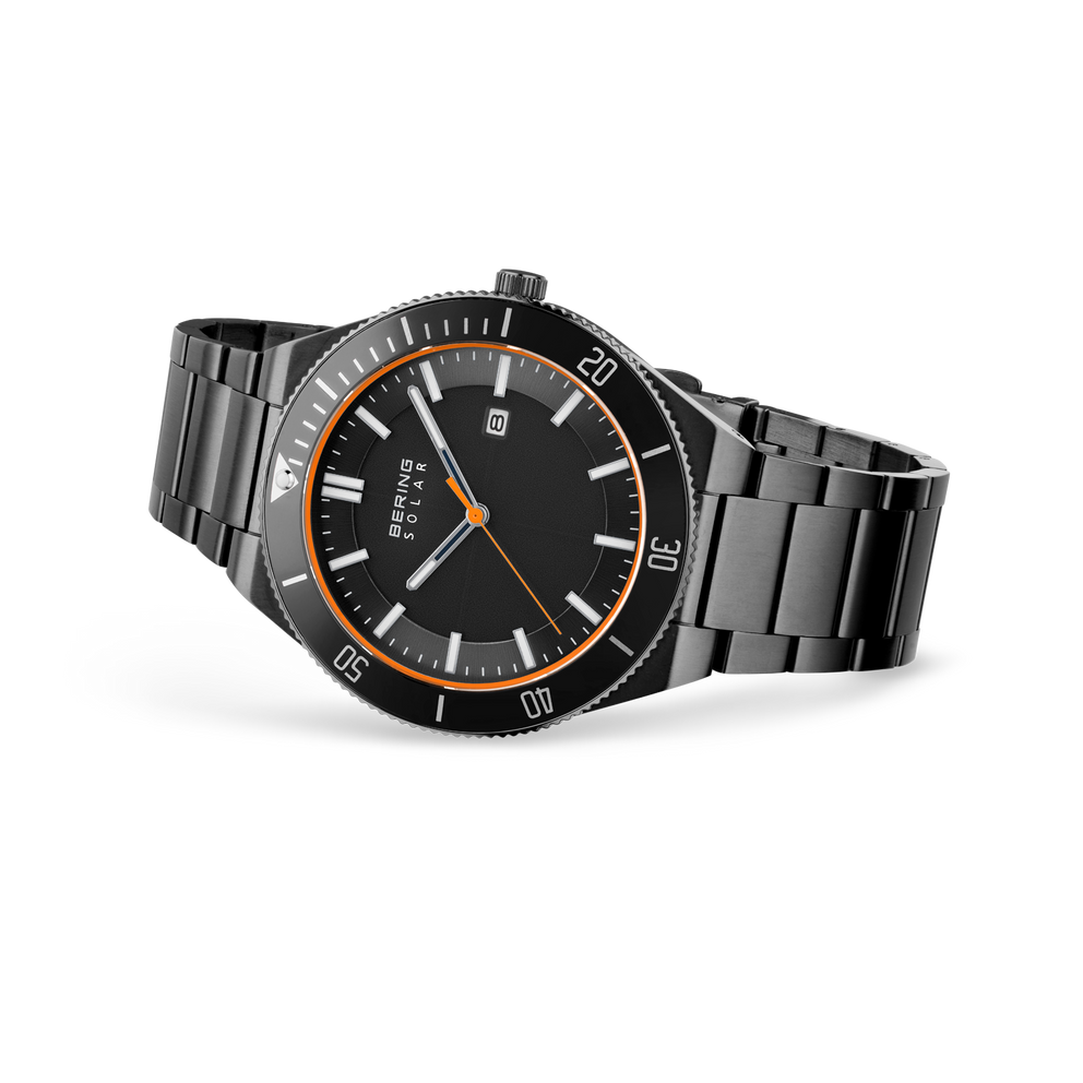 Black-dial wristwatch with metal bracelet, angled view showing orange bezel and hand accents, date window.