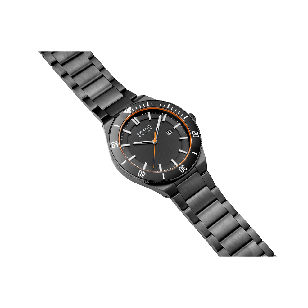 BERING wristwatch with black dial, orange accents, and gunmetal bracelet, angled to show watch face and full strap