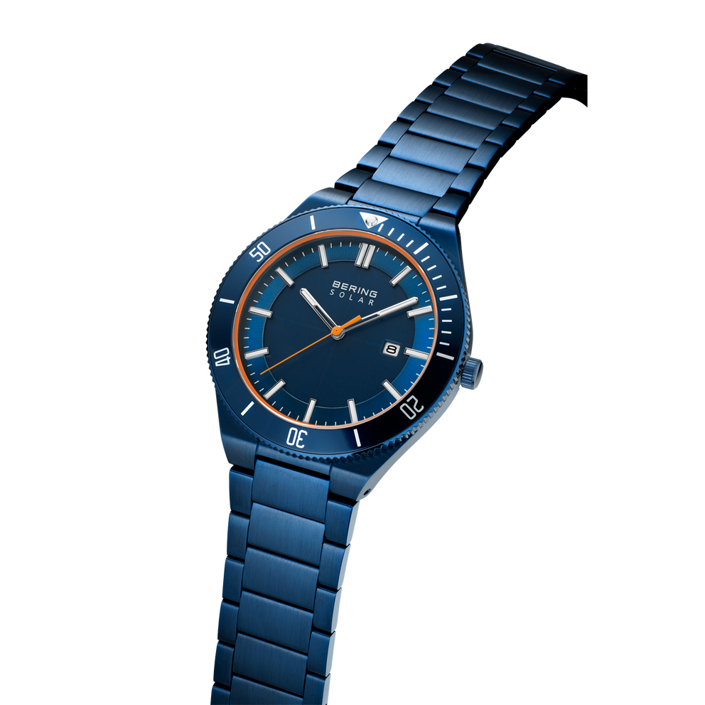 BERING watch in blue steel with link bracelet, three-quarter view showing case profile and bracelet construction.