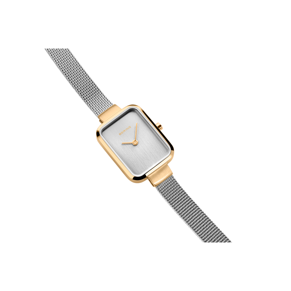 Rectangular watch with rose gold case and silver steel mesh strap, angled view