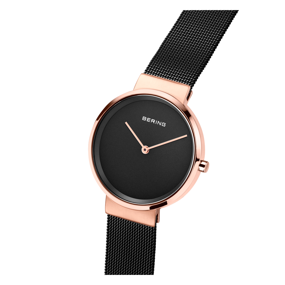 BERING wristwatch with rose gold case and black mesh strap, displayed at an angle