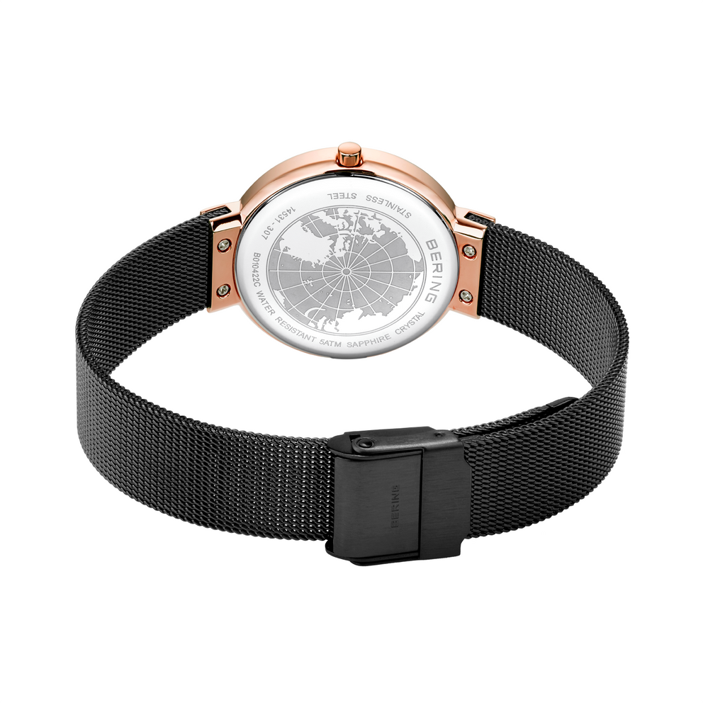 Watch with rose gold case and black mesh band, shown from above with back detail visible