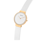 Orologio BERING con cassa rotonda dorata, lunetta con cristalli, quadrante bianco e cinturino bianco, vista laterale.