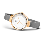 Wristwatch with rose gold bezel and black mesh band, white dial with minimalist markers, shown at three-quarter angle.