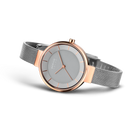 BERING watch with rose gold case and silver mesh bracelet, angled view showing gray dial and three hands.