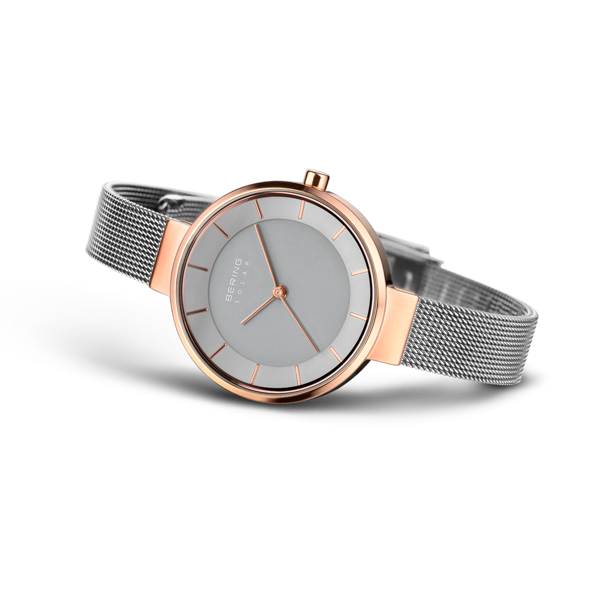 BERING watch with rose gold case and silver mesh bracelet, angled view showing gray dial and three hands.
