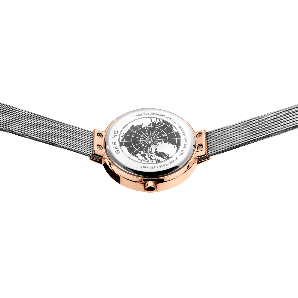 Top-down view of rose gold watch with white dial and grey mesh band