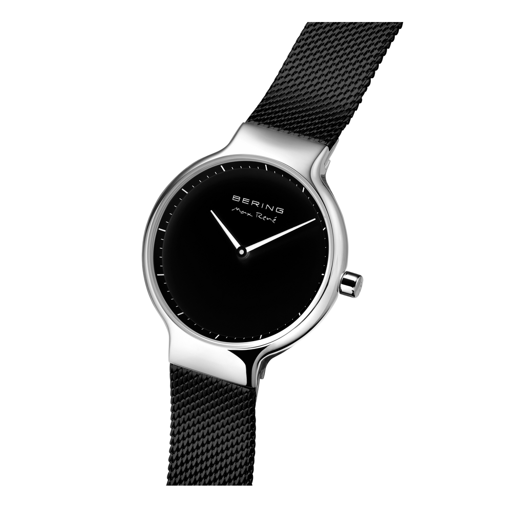 BERING watch with black mesh band extended, angled flat-lay composition showing watch and band