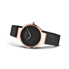 BERING watch with rose-gold case, black dial and white hands, black mesh strap, shown at an angle
