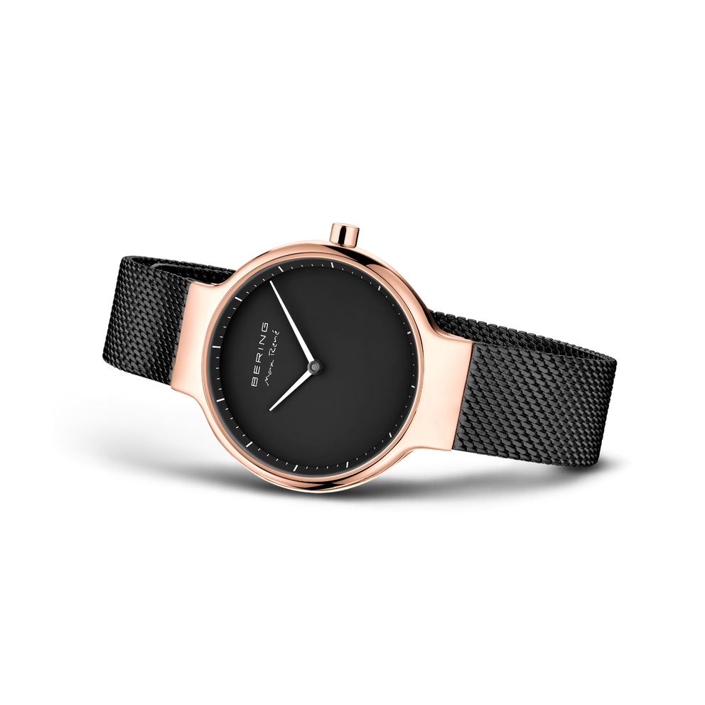 BERING watch with rose-gold case, black dial and white hands, black mesh strap, shown at an angle