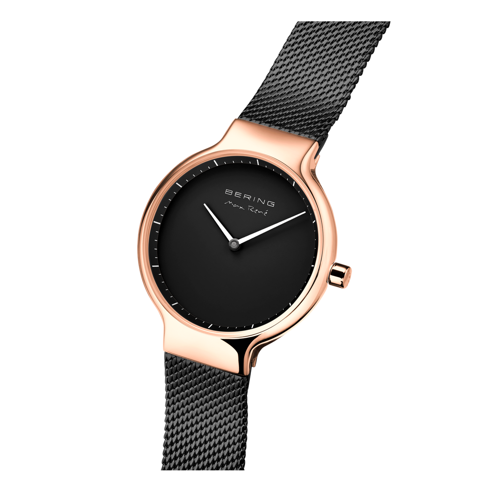 Watch with rose gold case, black dial and white hands, paired with black mesh bracelet in three-quarter view.