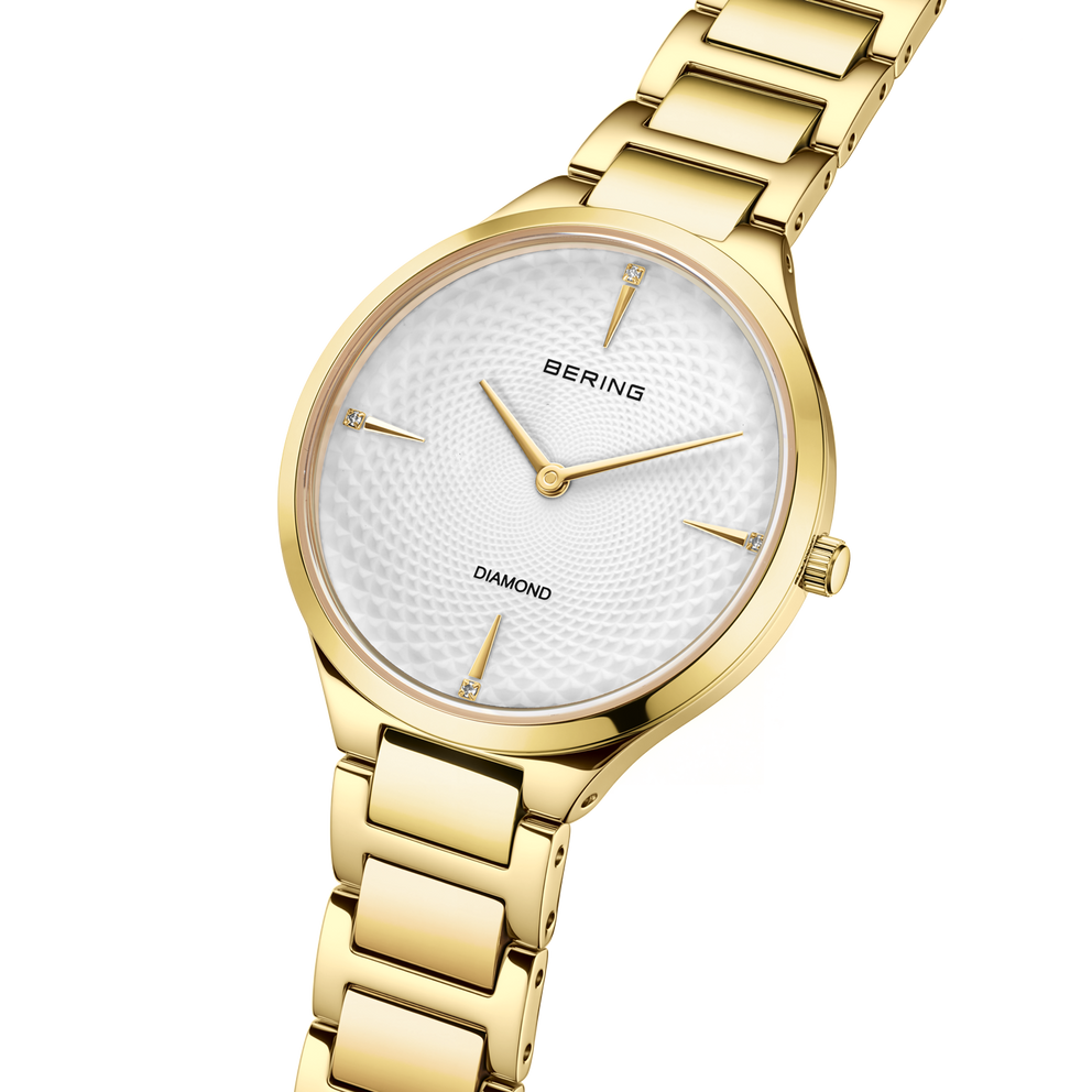 Orologio BERING tonalità oro con quadrante bianco, marcatura Diamond e braccialetto a maglie coordinato.
