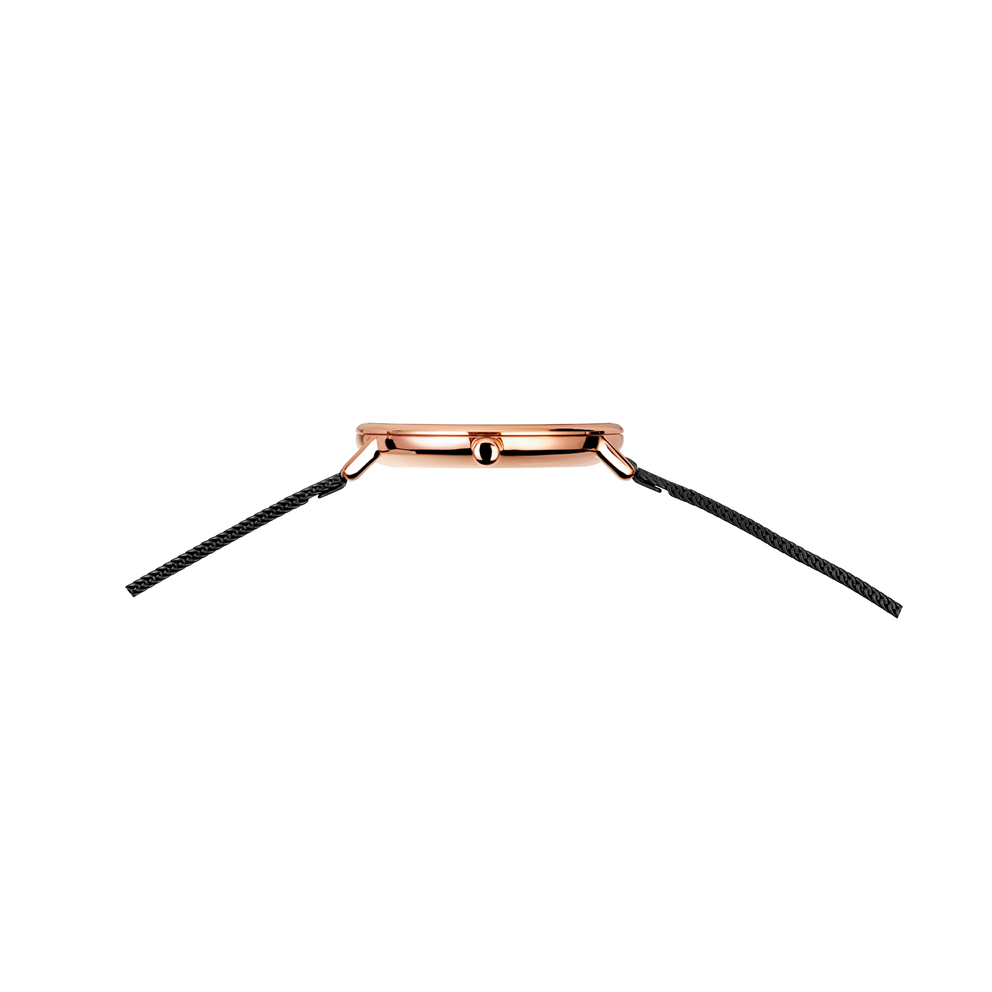 Top view of rose gold round watch case with black textured strap