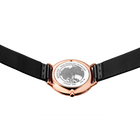 Rose gold watch with world map dial and black mesh strap, viewed from above