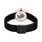 Wristwatch with rose gold case and black mesh band, dial visible in center, rear view