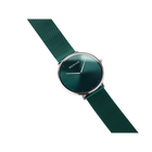 BERING wristwatch with dark teal dial, silver case, and matching teal fabric strap, angled view