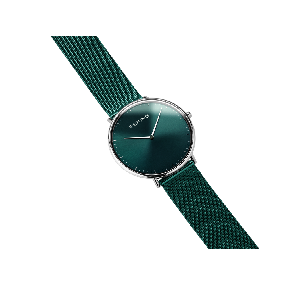 BERING wristwatch with dark teal dial, silver case, and matching teal fabric strap, angled view