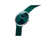 Wristwatch with teal dial, metal case, and mesh band shown at angle highlighting case and strap