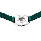 Round silver watch with dark green fabric strap, shown from above with engraved circular dial detail visible.