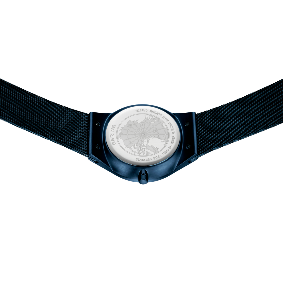 Wristwatch with silver dial and dark blue case, black strap, viewed from above.