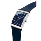 Rectangular steel watch with dark blue face and white numerals, paired with navy textile strap, shown at angle.