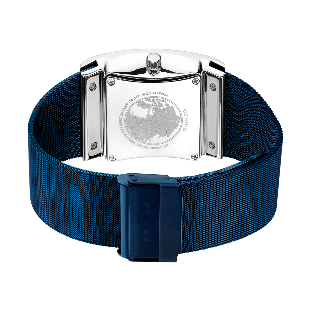 Watch caseback with engraved globe emblem, shown with blue mesh band.
