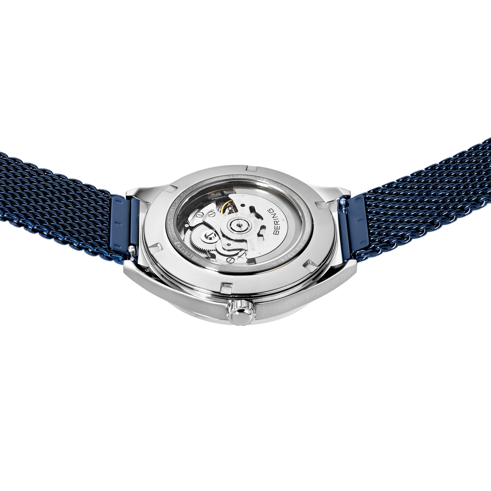 Watch caseback with embossed logo, polished steel case, dark blue mesh band