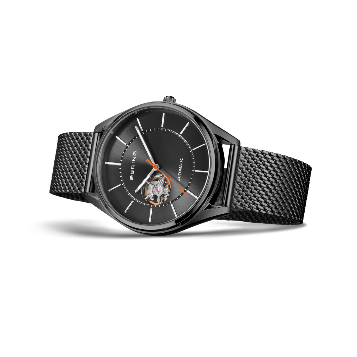 Wristwatch with round dark dial, hour markers, and open window detail; black mesh band.