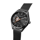 BERING automatic watch, black dial with visible rotor, mesh strap, angled view