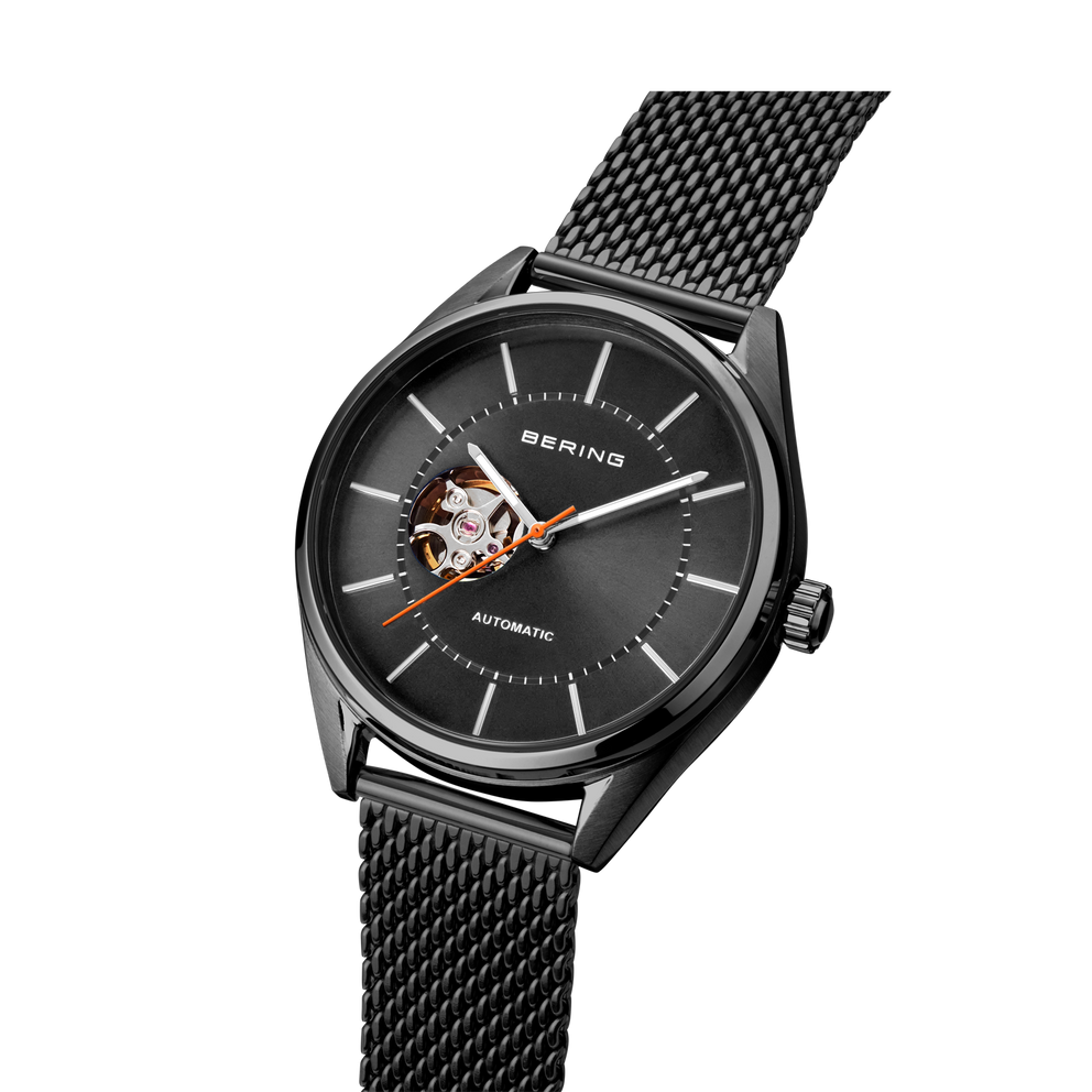 BERING automatic watch, black dial with visible rotor, mesh strap, angled view
