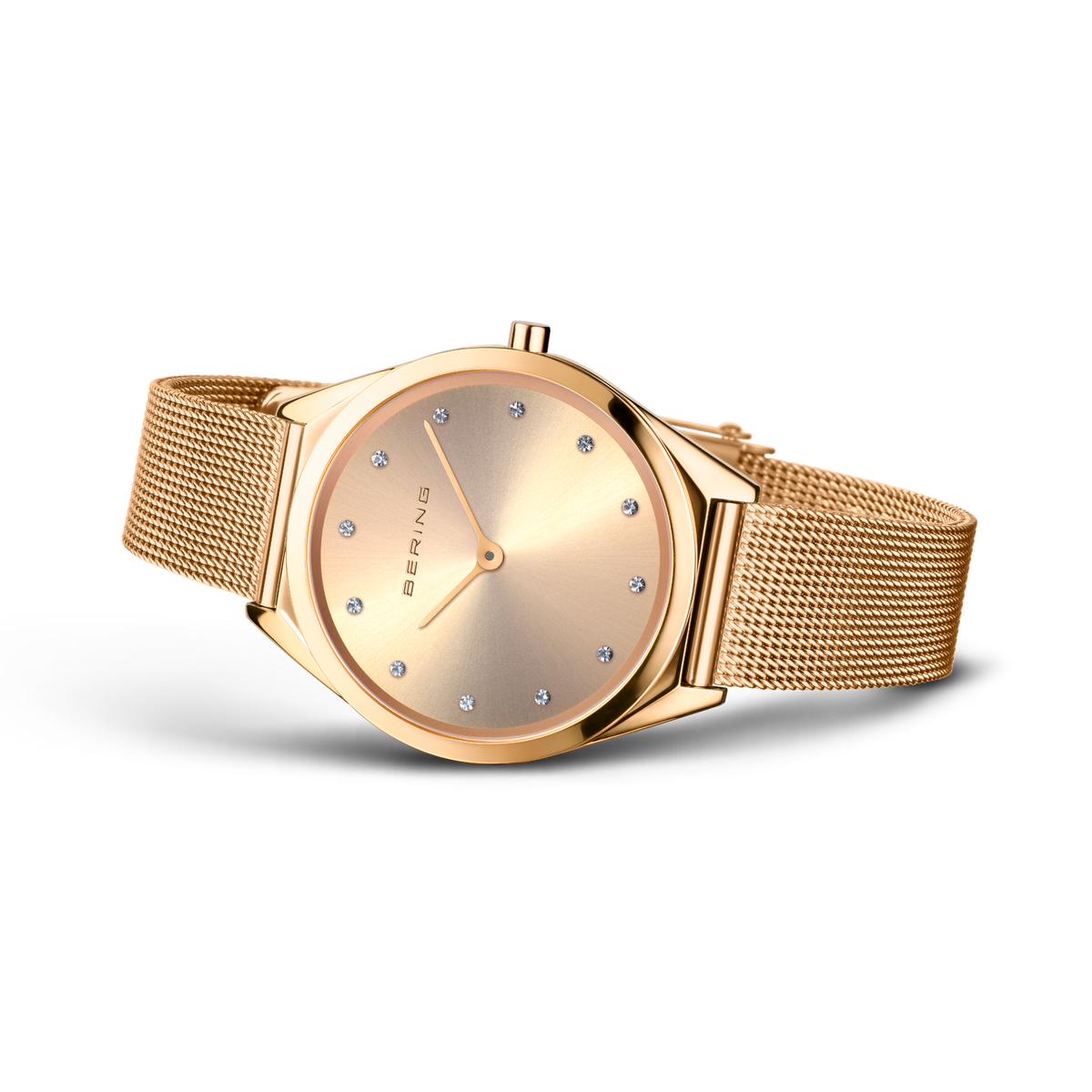 Gold-tone wristwatch with round case and champagne dial with hour markers, shown with mesh bracelet strap.