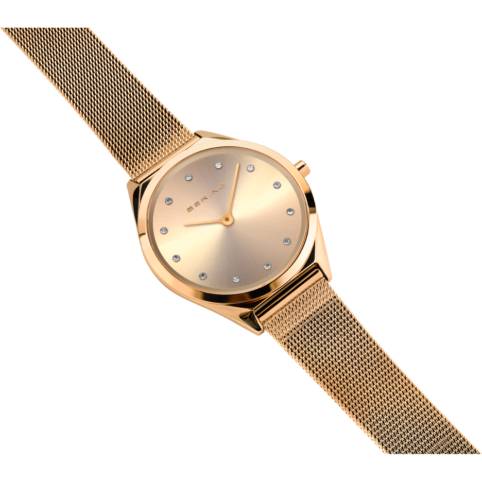 Rose gold wristwatch with mesh band displayed at an angle, showing the case and full band.