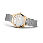 Orologio BERING bicolore: cassa oro rosa, cinturino maglia argento, quadrante bianco minimalista, vista angolata.
