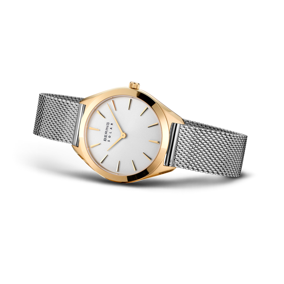 Orologio BERING bicolore: cassa oro rosa, cinturino maglia argento, quadrante bianco minimalista, vista angolata.