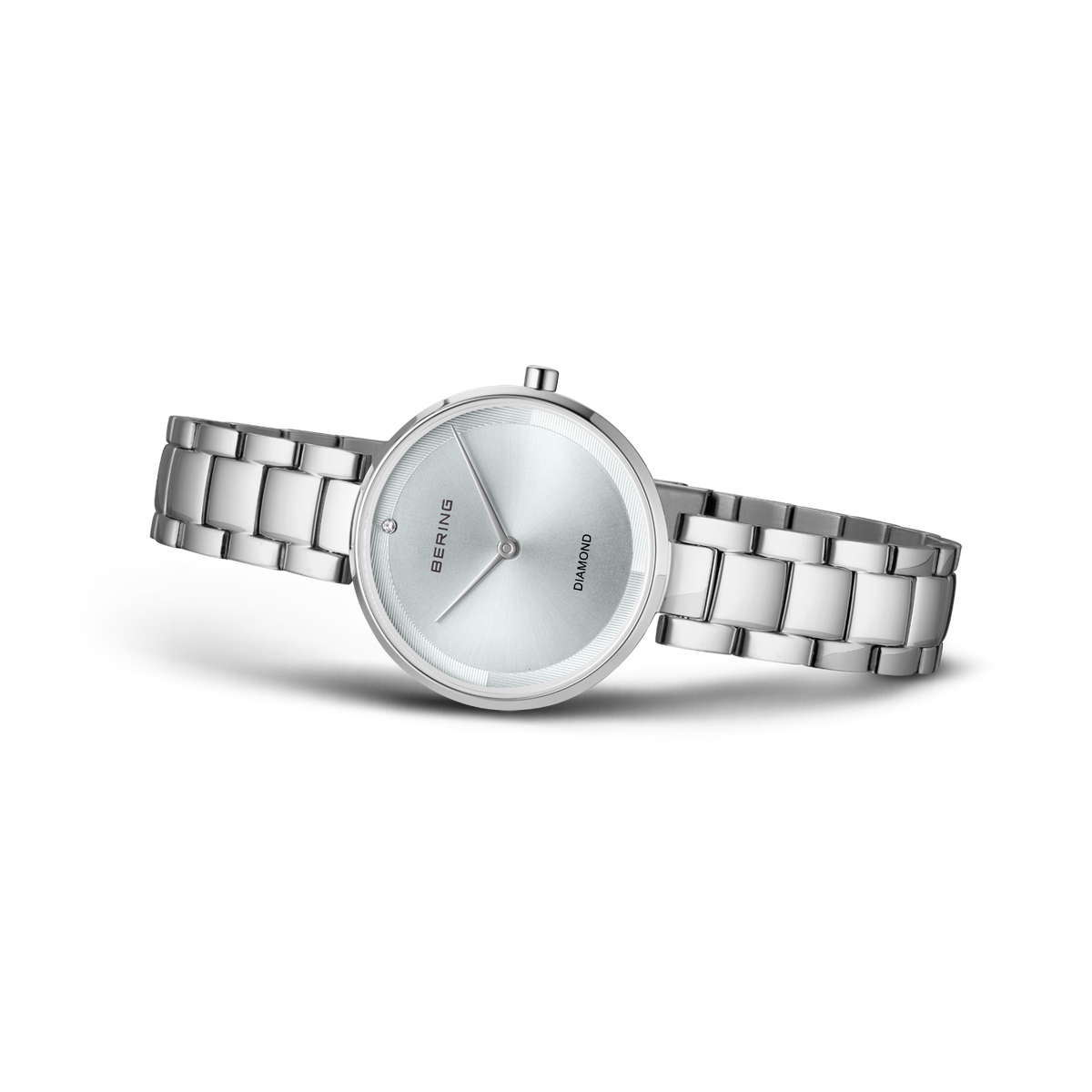 Montre ronde à bracelet chaîne acier argenté, cadran épuré, photographiée de profil.