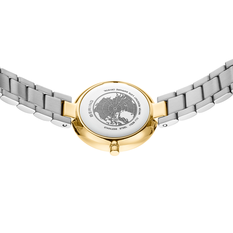 Watch caseback with engraved BERING logo on two-tone silver and gold bracelet