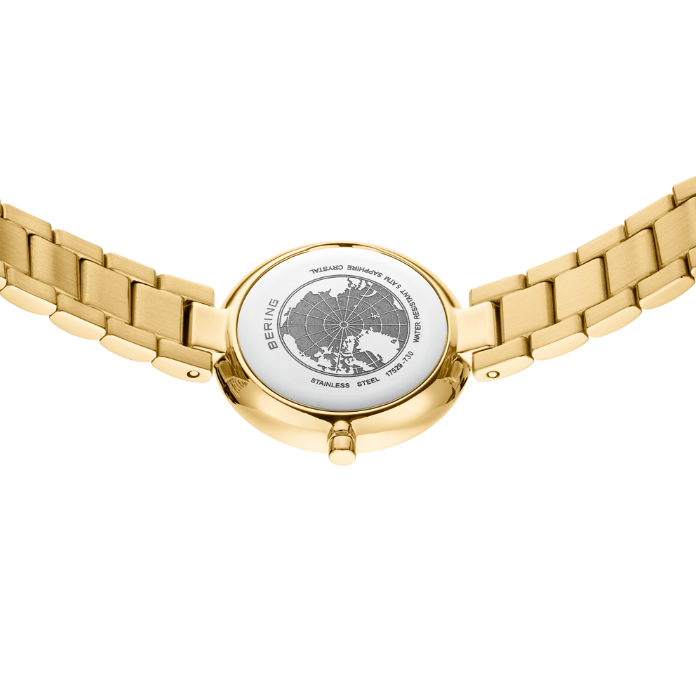 Parte trasera del reloj dorado con águila grabada